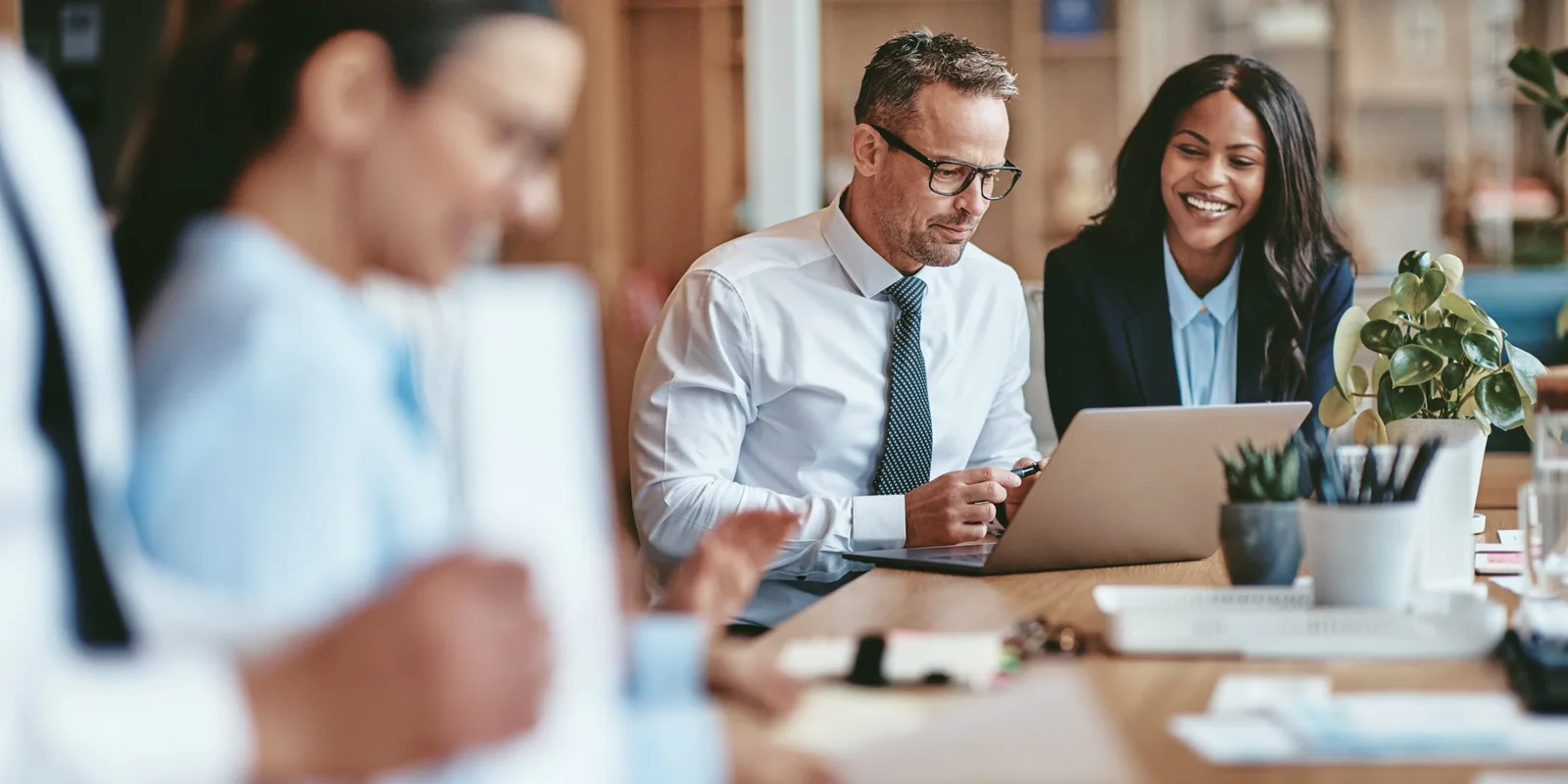 Office workers sitting around a conference table