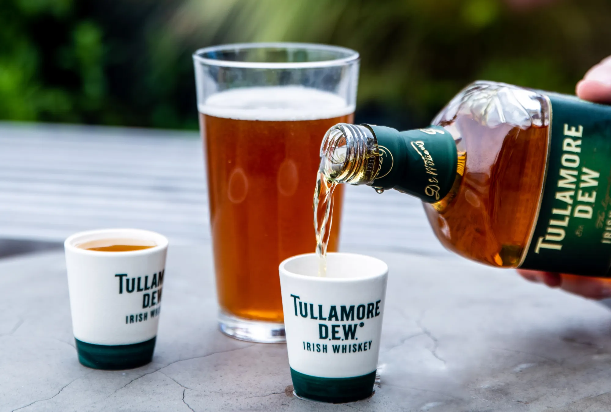bottle of Tullamore D.E.W. pouring into shot glass